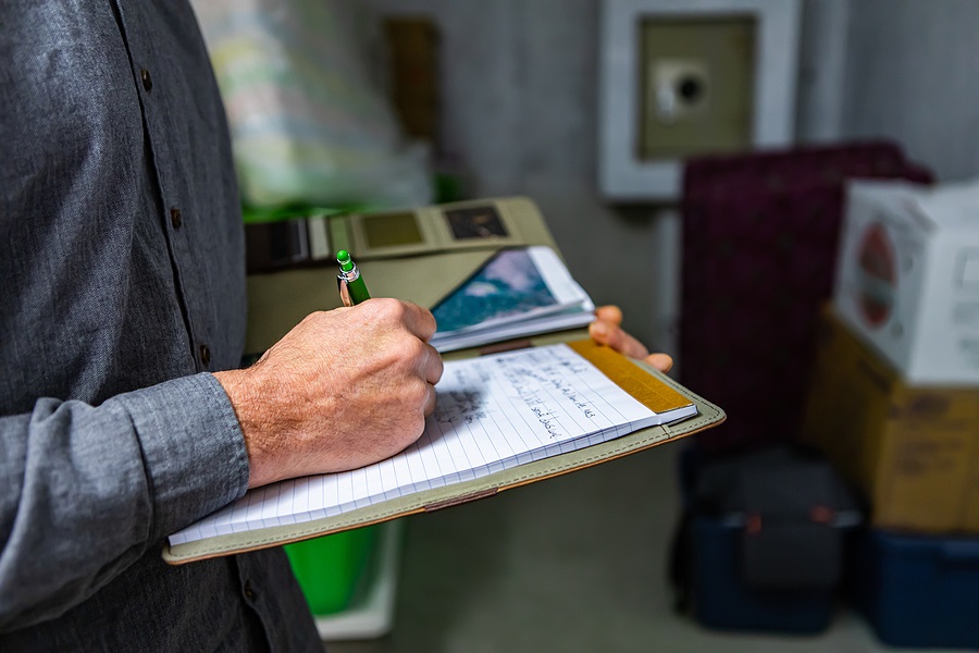 Property management rep taking notes in notebook